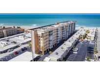 Expansive aerial view of beach condo building with stunning beachfront location and ample parking at 1255 Tarpon Center Dr # 503, Venice, FL 34285
