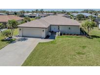 Charming single-story home with a well-manicured lawn and a two-car garage at 1602 Jim Jim Ct, Venice, FL 34293