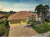 Beautiful home featuring a lush front yard, brick paved driveway, tile roof and a two-car garage at 1662 Bobcat Trl, North Port, FL 34288