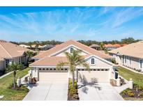 Inviting home featuring a well-manicured lawn, a tile roof, and a spacious driveway at 1683 San Silvestro Dr, Venice, FL 34285