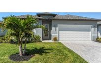 Beautiful home with a well-manicured lawn, nice walkway and a two-car garage at 16848 Cayo Key Dr, Port Charlotte, FL 33953
