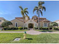 Stunning Mediterranean-style building with lush landscaping, palm trees, and a brick walkway at 206 Bella Vista Ter # 29A, Nokomis, FL 34275