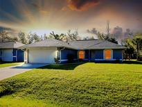 Charming single-story home featuring a well-manicured lawn and two-car garage at 3447 Nadasky Ave, North Port, FL 34288
