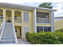 Attractive two-story condo featuring shuttered windows, and a private screened in porch at 418 Cerromar Ct # 261, Venice, FL 34293