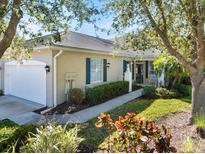 Charming single-story home with lush landscaping, blue shutters and a tile roof at 915 Tartan Dr # 29, Venice, FL 34293