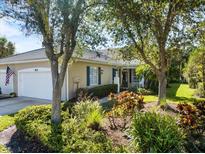 Charming home featuring a well-manicured front yard with vibrant landscaping and a welcoming entrance at 915 Tartan Dr # 29, Venice, FL 34293