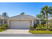 Charming single-story home featuring a two-car garage and well-manicured landscaping at 1572 Monarch Dr, Venice, FL 34293