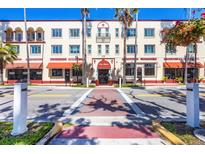 View of a three story commercial building featuring awnings and Spanish architecture at 238 Tampa W Ave # 217, Venice, FL 34285