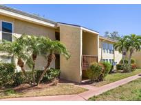 Inviting condo exterior featuring a private balcony and lush tropical landscaping at 3417 Clark Rd # 217, Sarasota, FL 34231