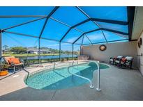 Relaxing screened-in pool area with a tranquil lake view, perfect for enjoying the outdoors in comfort at 3459 Lakewood Blvd, North Port, FL 34287