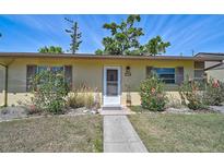 Charming front entrance of home with a well-manicured lawn and walkway to the front door at 4437 Tippecanoe Trl # 6, Sarasota, FL 34233