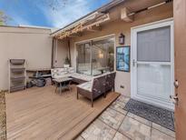 Charming back patio with cushioned seating, awning with string lights, and stone tile entryway to the home at 500 N Jefferson Ave # A3, Sarasota, FL 34237