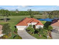 Expansive single-Gathering home boasts tile roof and pristine landscaping on a lush lot with water view at 6210 Cormorant Ct, Bradenton, FL 34203