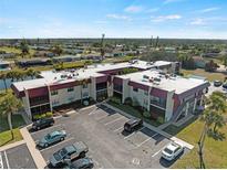Spacious condo complex featuring ample parking and landscaping at 66 Boundary Blvd # 275, Rotonda West, FL 33947