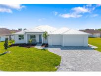 Beautiful one story home with a metal roof, manicured lawn, and a paved driveway at 7407 S Blue Sage, Punta Gorda, FL 33955