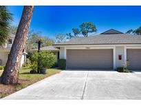 Charming home featuring a two-car garage, well-manicured landscaping, and a welcoming entrance at 7941 Pineglen Ct # 37, Sarasota, FL 34238