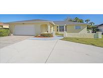 Charming single-story home with a well-manicured lawn and a two-car garage with ample driveway space at 1003 N Gondola Dr, Venice, FL 34293