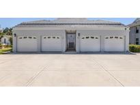 A multi-car garage with concrete driveway offers plenty of parking at 1041 Capri Isles Blvd # 224, Venice, FL 34292