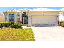 Inviting one-story home with a two-car garage, complemented by mature landscaping at 14 Windward Ter, Placida, FL 33946