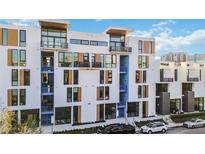 Modern townhouse exterior boasting contemporary design with balconies and ample street parking at 1558 4Th St # 208, Sarasota, FL 34236