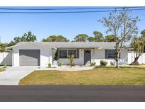 Charming single-story home with a well-manicured front yard and inviting curb appeal at 1600 Maryknoll Rd, Englewood, FL 34223