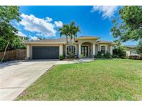 Charming single-story home boasts mature landscaping, a two-car garage, and a welcoming front entrance at 740 Tanager Rd, Venice, FL 34293
