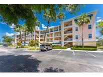 Condominium building with balconies, palm trees, and parking in a coastal community at 8403 Placida Rd # 205, Placida, FL 33946