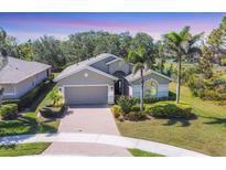 Charming single-story home featuring a brick driveway, attached garage, and well-maintained landscaping at 9312 Coachman Dr, Venice, FL 34293