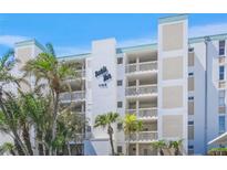 Bahia Mar condominium building with multiple balconies and lush landscaping at 1100 Tarpon Center Dr # 104, Venice, FL 34285