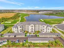 Luxury condo complex featuring covered parking, a pristine lake, and a beautiful golf course at 12140 Wellen Golf St # 401, Venice, FL 34293