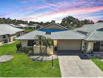 Charming home with a tile roof, well-manicured lawn, and a two-car garage at 131 Sandstone Cir, Venice, FL 34293