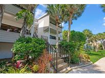Inviting condo with lush landscaping, palm trees and beautiful curb appeal at 1555 Tarpon Center Dr # 156, Venice, FL 34285