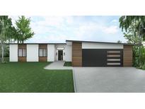 Modern single-story home with a flat roof, a black garage door, and wood and white siding at 1804 Nimbus Dr, North Port, FL 34287