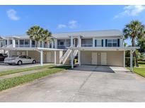 Charming condo building with covered parking, lush landscaping, and easy access to nearby amenities at 432 Sunset Lake Blvd # 205, Venice, FL 34292