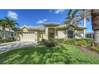 Charming single-story home featuring a lush lawn, well-manicured landscaping, and a two-car garage at 525 Cheval Dr, Venice, FL 34292