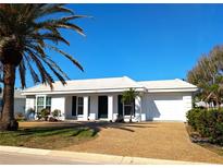 Charming single-story home featuring a well-maintained lawn and a classic white exterior at 926 Inlet Cir, Venice, FL 34285