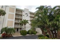 Bahia Mar condo building featuring multi-level balconies and lush tropical landscaping at 1100 Tarpon Center Dr # 102B, Venice, FL 34285