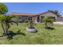 Charming single-story home with lush lawn and mature palm trees in a desirable location at 1340 Olympia Rd, Venice, FL 34293