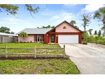 Charming single-story home with a well-maintained lawn, a two-car garage, and attractive landscaping at 304 Beach Rd, Venice, FL 34285