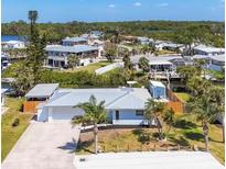 Waterfront home featuring a new roof, lush landscaping and an expansive driveway at 507 Buena Vista Dr, Nokomis, FL 34275