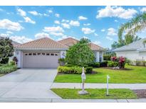 Charming single-story home with lush landscaping, tile roof, and a two-car garage at 5189 Pine Shadow Ln, North Port, FL 34287