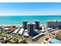 Stunning aerial view of beachfront condos with turquoise waters and parking at 627 Alhambra Rd # 1103, Venice, FL 34285