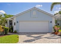 Charming home featuring a two-car garage and paved driveway at 1625 Lancashire Dr, Venice, FL 34293