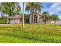 Charming single-Gathering home with a well-manicured lawn and palm trees in a sunny environment at 4305 Sandune Ave, North Port, FL 34287