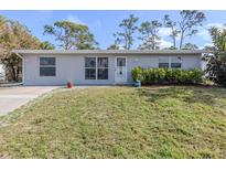 Charming single-story home featuring a well-maintained lawn and a welcoming front entrance at 8132 Coco Solo Ave, North Port, FL 34287
