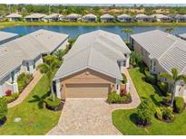 Beautiful single-Gathering home with a brick paved driveway and well-manicured landscaping at 11026 Barnsley Dr, Venice, FL 34293