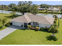 Charming single-story home with a well-manicured lawn and waterfront view at 1232 Pine Needle Rd, Venice, FL 34285