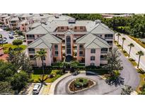 Stunning exterior view of a condo with a landscaped roundabout and lush tropical landscaping at 1711 Gondola Park Dr # 1711, Venice, FL 34292