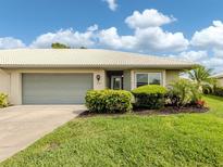 Charming single-story home with well-manicured lawn and a two-car garage, complemented by lush landscaping at 3167 Night Heron Ln, Venice, FL 34293