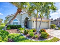 Charming single-story home with lush landscaping, healthy palm trees, and a well-manicured lawn at 3337 Pine Shadow Cir, North Port, FL 34287